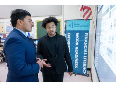 A teacher speaking with a student about financial literacy